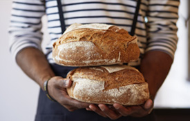Baker holding bread